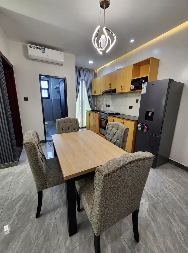 Furnished unit dining and kitchen space at Elevate Heights Apartment